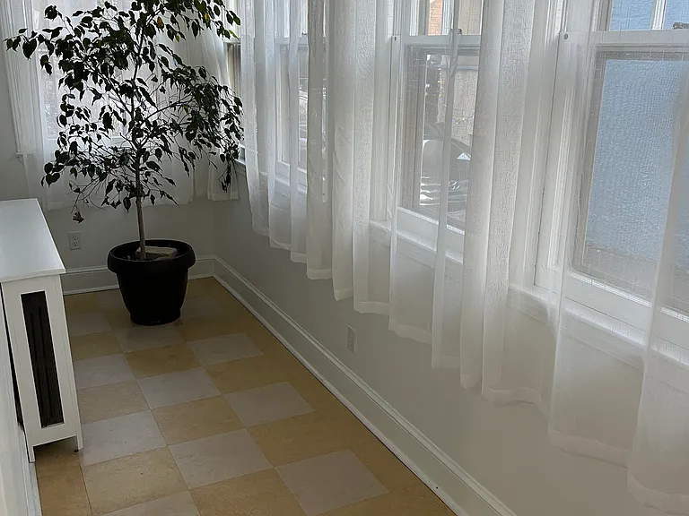 Sunroom wide enough for a small desk which can be placed to face the front or rear of house.