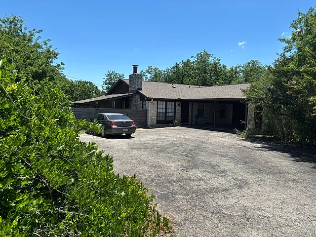 Driveway entry to carport and left front side of adjacent Unit A.