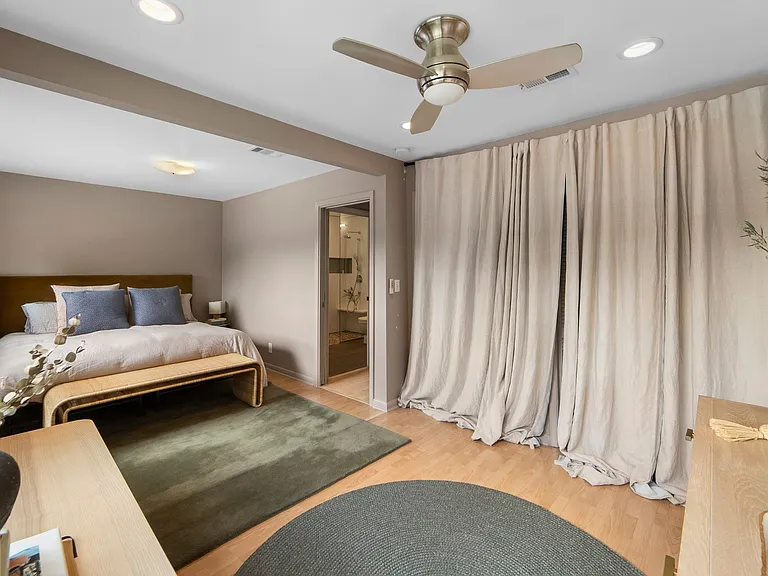 Primary bedroom. Closet space behind curtains.
