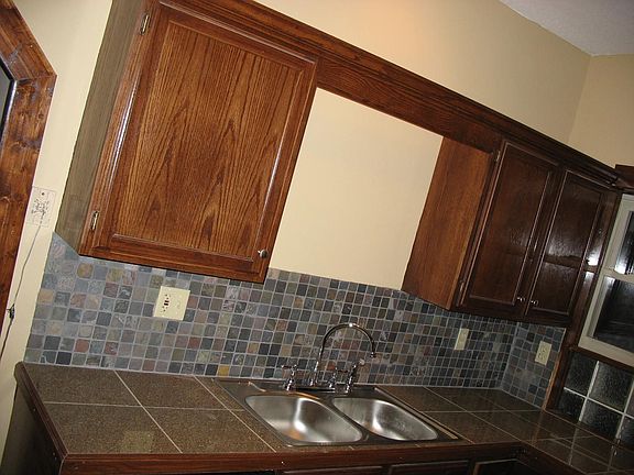 Kitchen with custom granite backsplash and cabinets