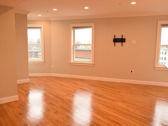 large living room with gleaming hardwood floors