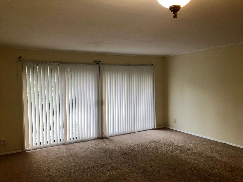 Spacious LR with large balcony facing wooded area.