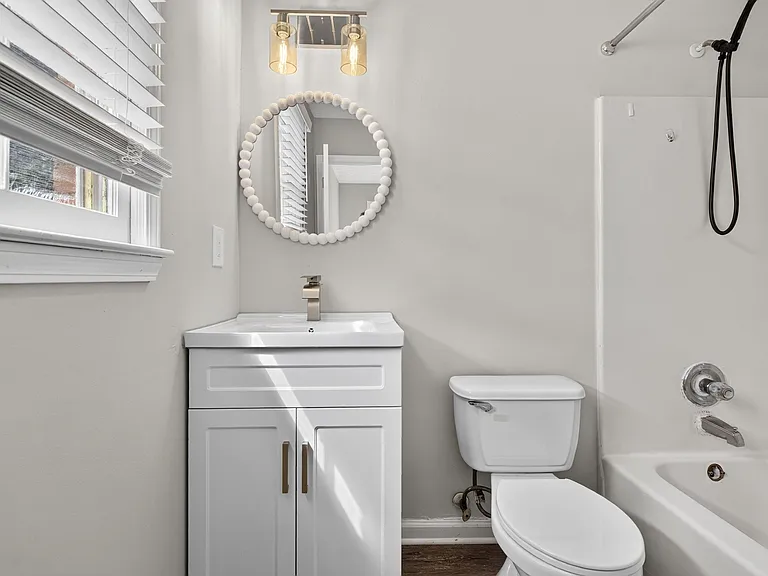 Well-appointed full bath with a modern vanity, updated lighting, and a tub/shower combo for everyday convenience.