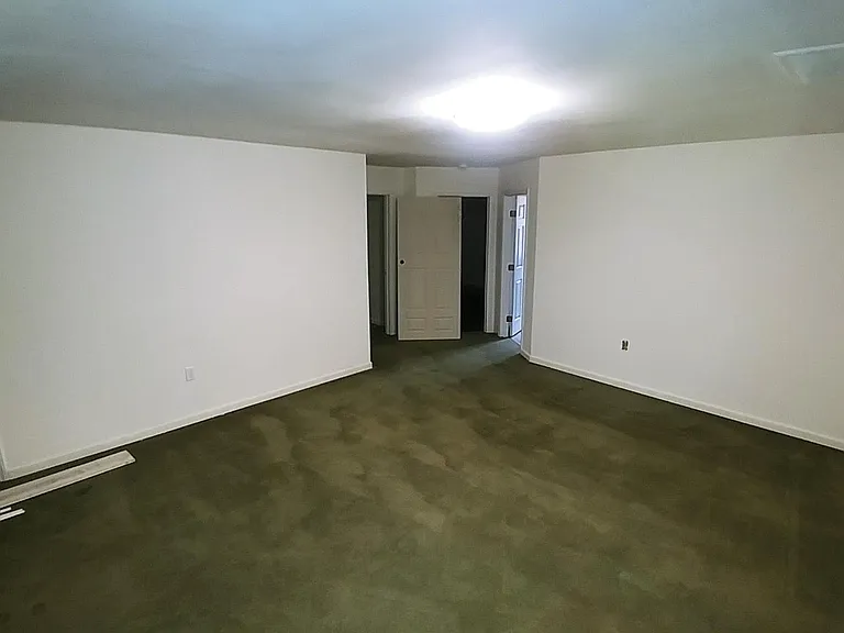 Another view of the living room, baby's room and walk-in closet