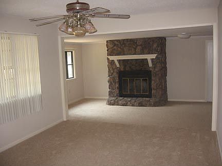 Living area features rock fireplace