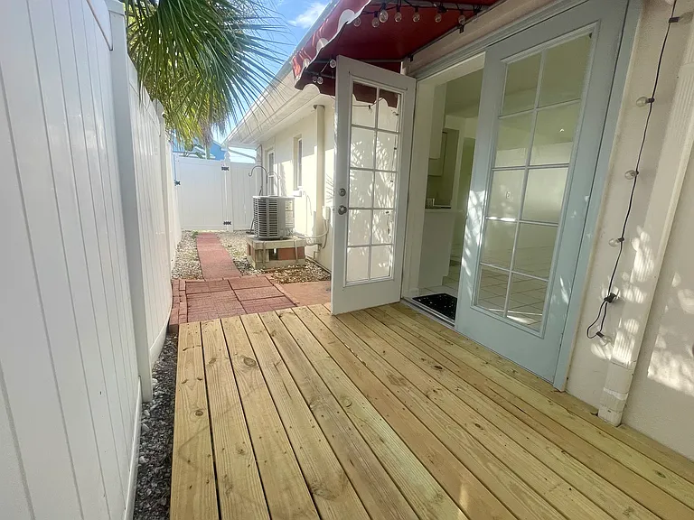 Doors leading to the kitchen from the private deck/patio area.