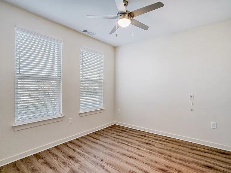 Unit Bedroom with Ceiling Fan and 2 Windows