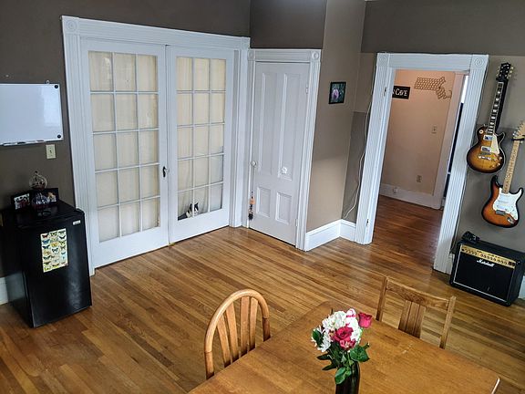 Dining room with french doors to bedroom, closet, and view into office