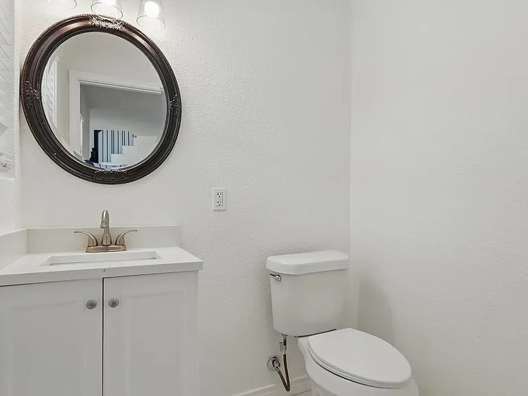 Half bath with toilet, vanity, and baseboards