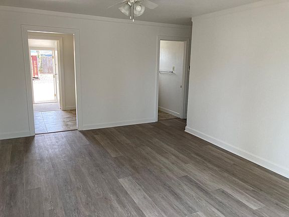 Living room looking to kitchen,through to utility room and backyard.