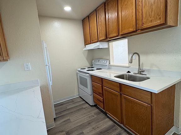 Kitchen includes stove/range, new stainless-steel sink and new refrigerator. Plenty of cabinet and counter space.