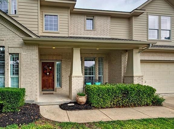 Guests are greeted by a lovely landscaped front porch.