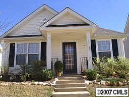Front of home has a welcoming porch along with landscaping and irrigation sys 