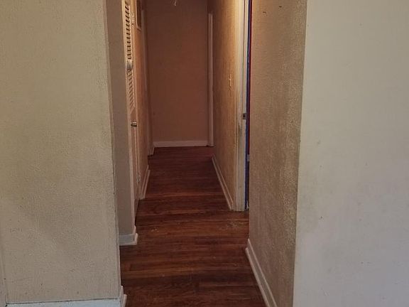 down stairs hallway to 3 bedrooms and 1 full bathroom