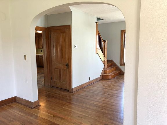 Standing in living room looking to kitchen door and stairway