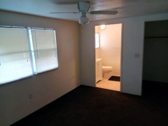 Master bedroom with half bath and walk in closet