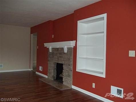 The new mantle and built in bookshelf accent the living room