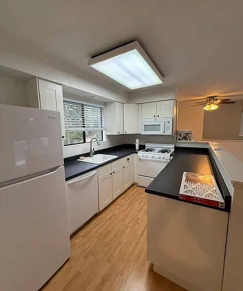 Kitchen with stove, refrigerator, microwave, and dishwasher