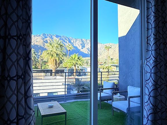 Looking out at the beautiful mountain view from the West Main Bedroom Deck with comfortable seating to relax and watch the sunset.