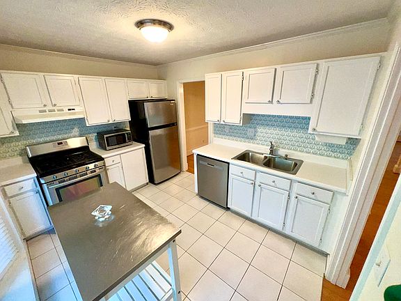 Kitchen with lots of light, has a bay window.