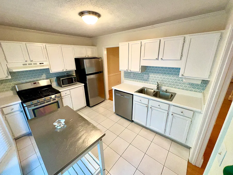 Kitchen with lots of light, has a bay window.