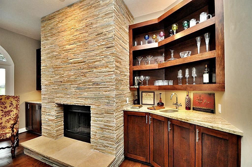 Contemporary Bar with stone fireplace & Hardwood floors in Sugar Land