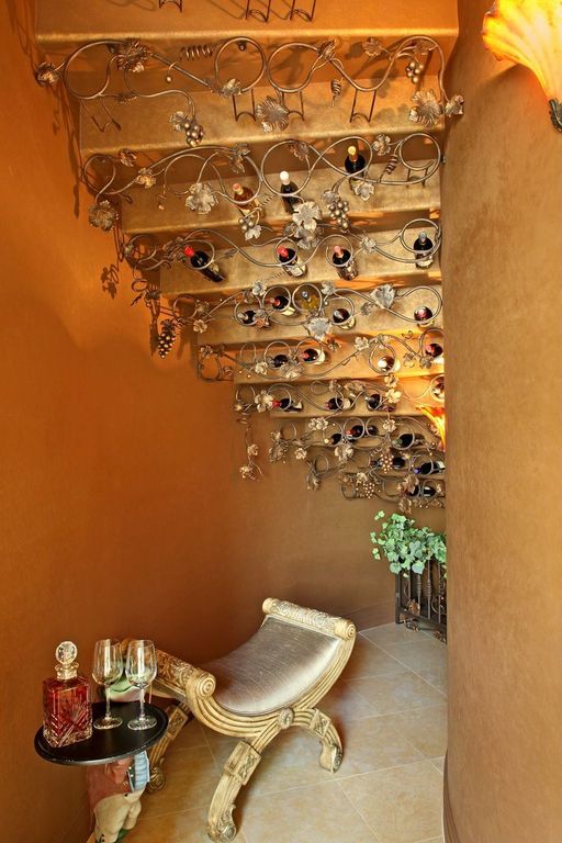 Eclectic Wine Cellar with terracotta tile floors & Wall sconce in LAS