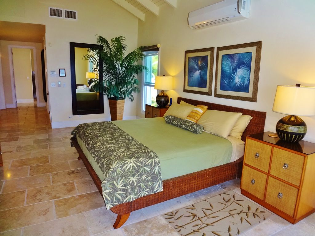 tropical master bedroom with travertine tile floors & high ceiling tropical master bedroom with travertine tile floors & high ceiling