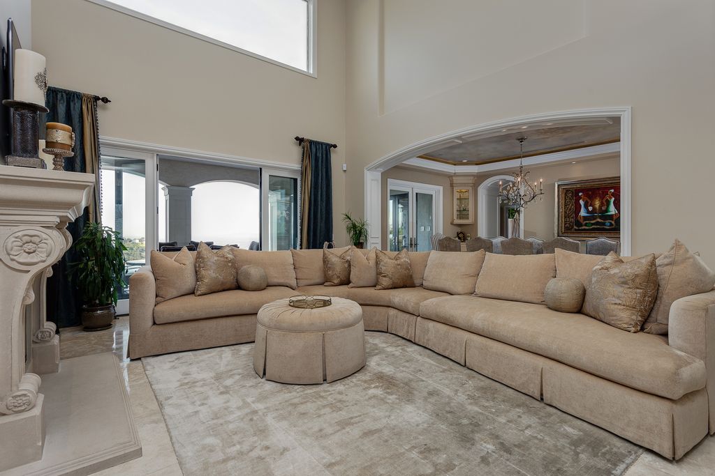 Traditional Living Room with limestone tile floors & High ceiling in