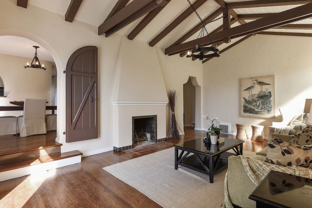 Traditional Living Room With Box Ceiling Stone Fireplace In Traditional Living Room With Hardwood Floors Chandelier Exposed Beam Stone Fireplace Cathedral