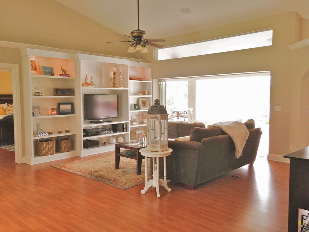 Traditional Living Room With Lighted Bookshelf Ceiling Fan In Traditional Living Room With Hardwood Floors Lighted Bookshelf Transom Window Ceiling Fan