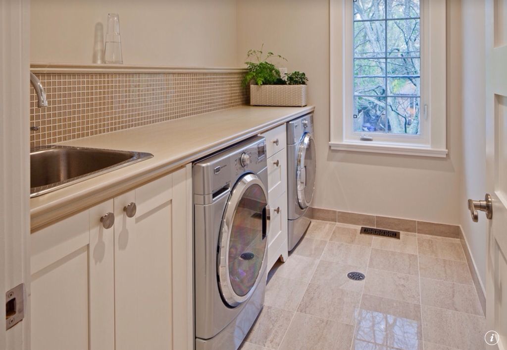 Traditional Laundry Room with specialty door & simple marble tile