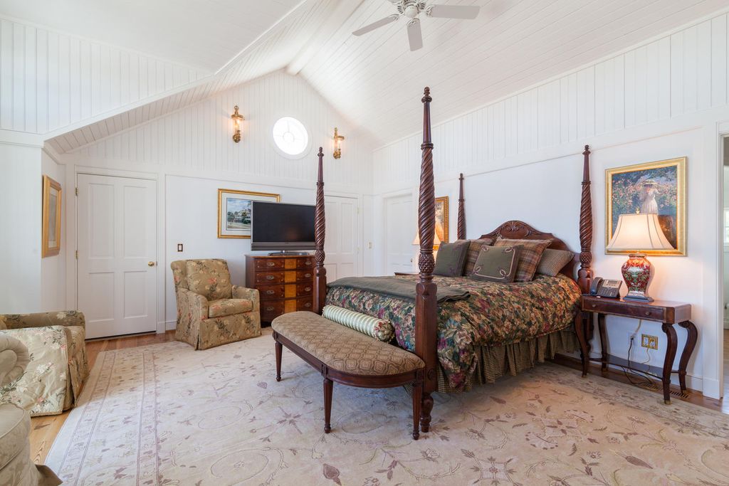 cottage master bedroom with exposed beam & ceiling fan in cottage master bedroom with exposed beam & ceiling fan in