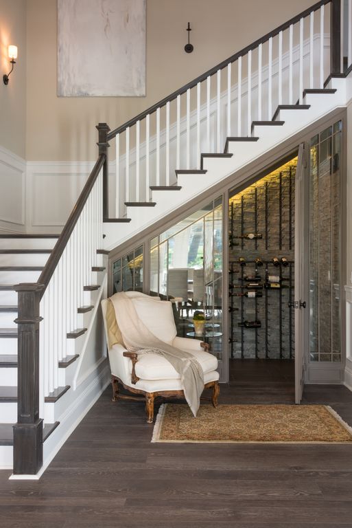 Traditional Wine Cellar with Builtin bookshelf by Jackie Turner