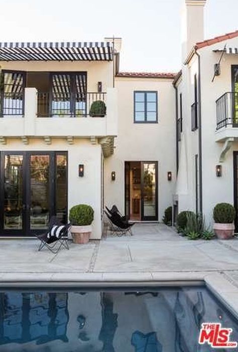 The courtyard just outside the kitchen/dining area and den has an outdoor fireplace. COME SEE MORE Rustic Spanish Villa Interior Design Inspiration!
