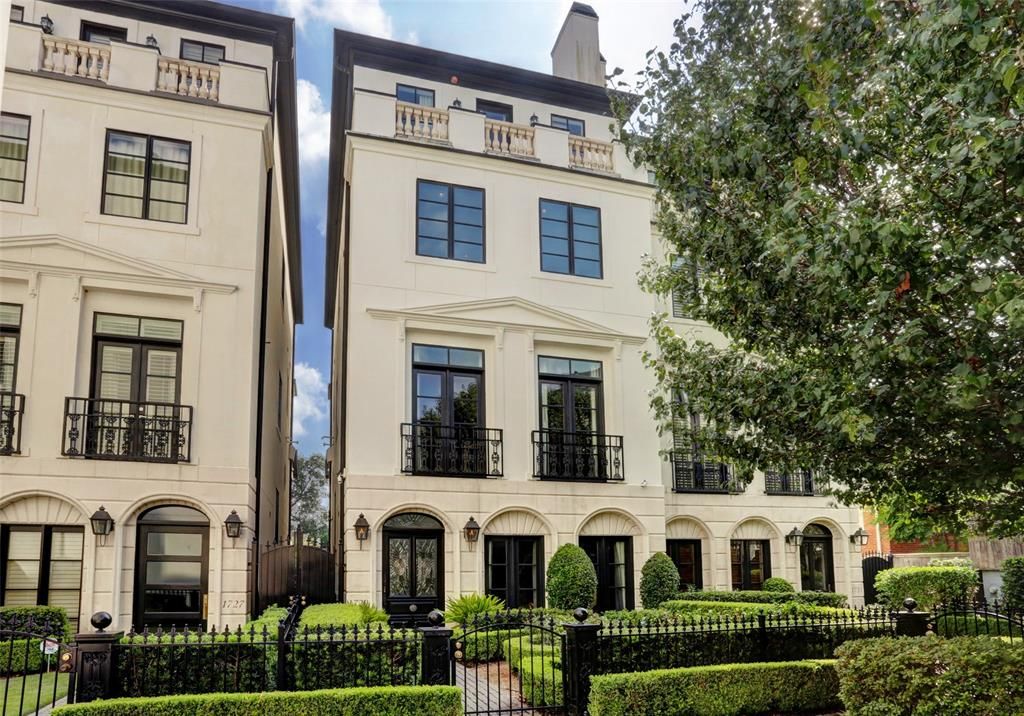 London townhome style with this stucco townhouse in Houston with dramatic interiors featuring black.