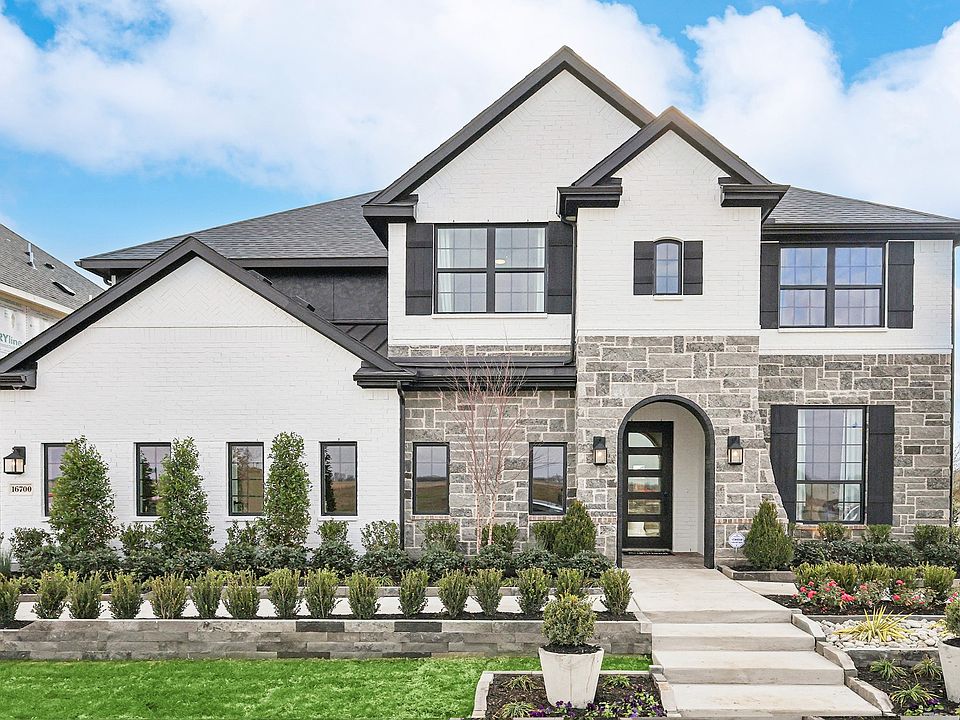 Sophisticated brick and stone facade with an arched entry in Green Meadows.