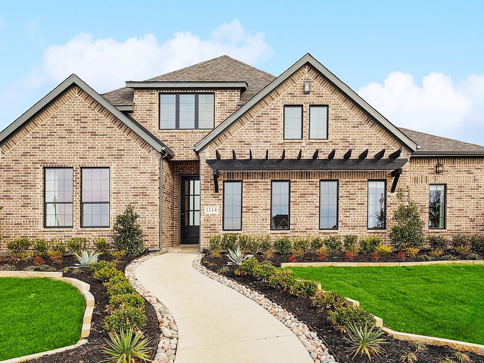 Experience refined elegance with brick exterior, expansive windows, in Westside Preserve.
