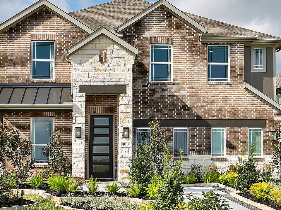 Luxurious brick facade with exquisite stone accents and lush landscaping in Clear Creek s prestigiou