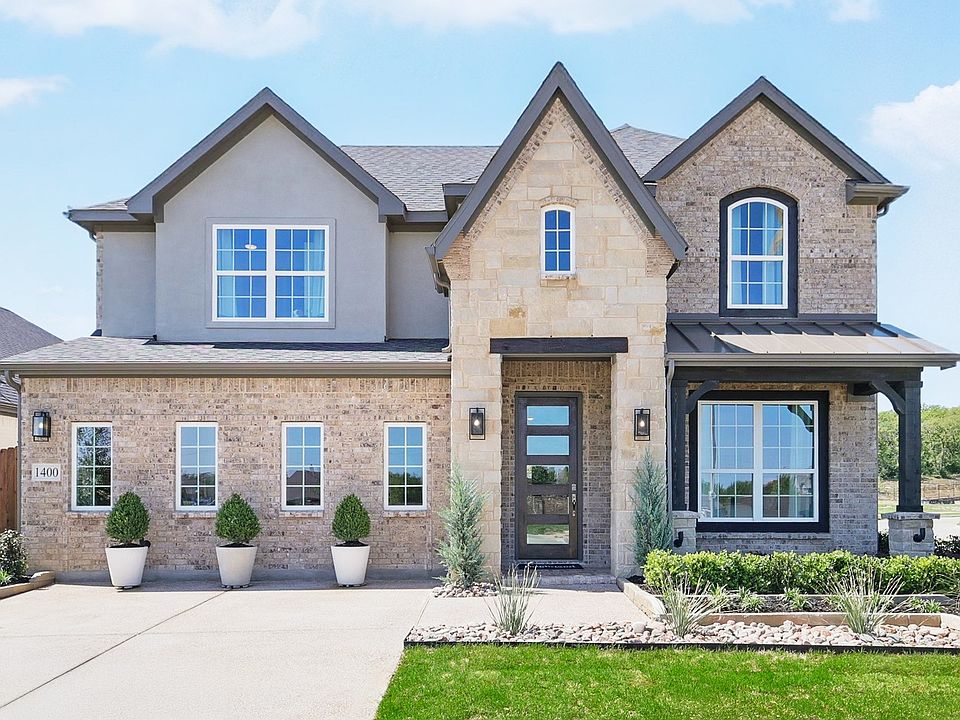 Exquisite brick facade and modern gabled architecture in prestigious Green Oaks Preserve.