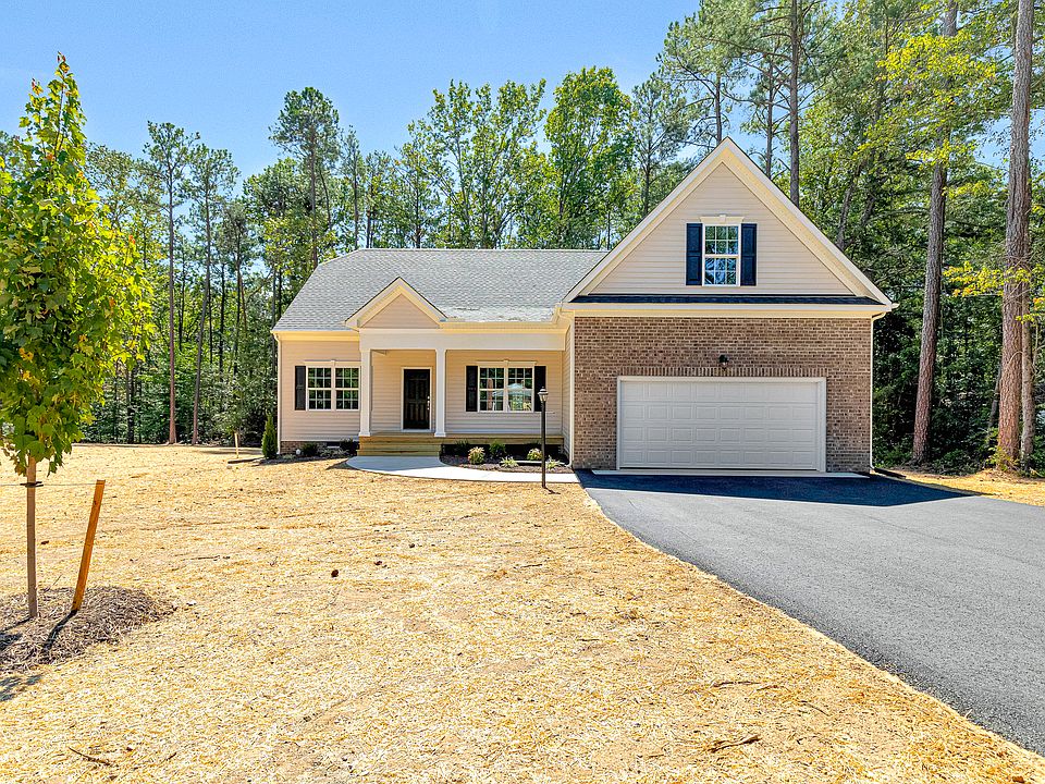 Single-story home in Patrick Henry Heights, Lot 57, with garage, porch, driveway, and a newly landsc