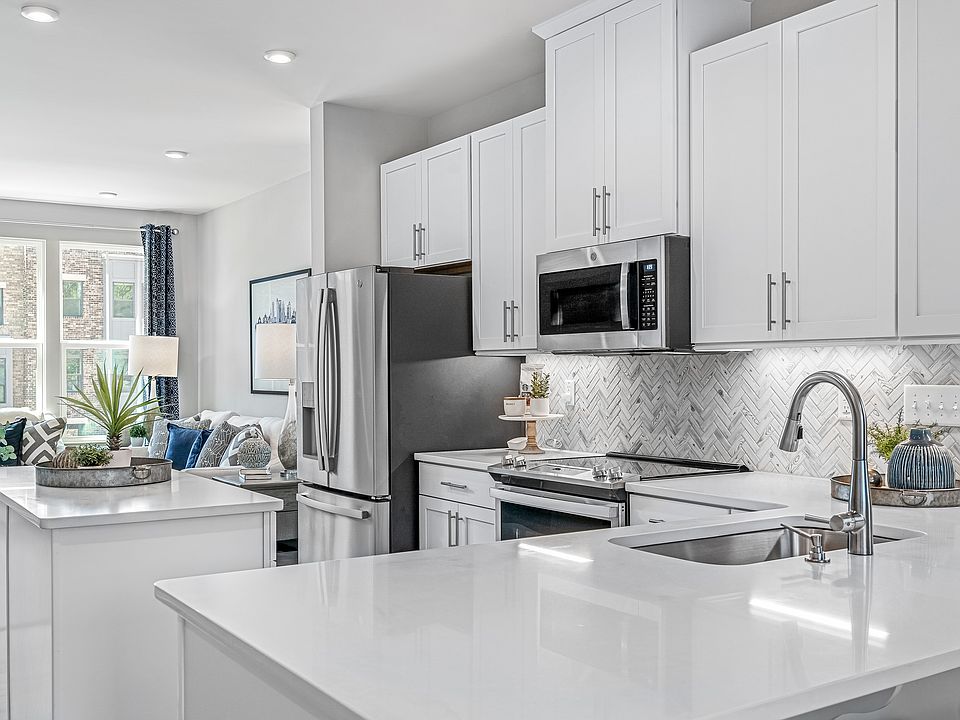 Modern waterfront townhomes with rooftop views, garage parking, and walkable city access