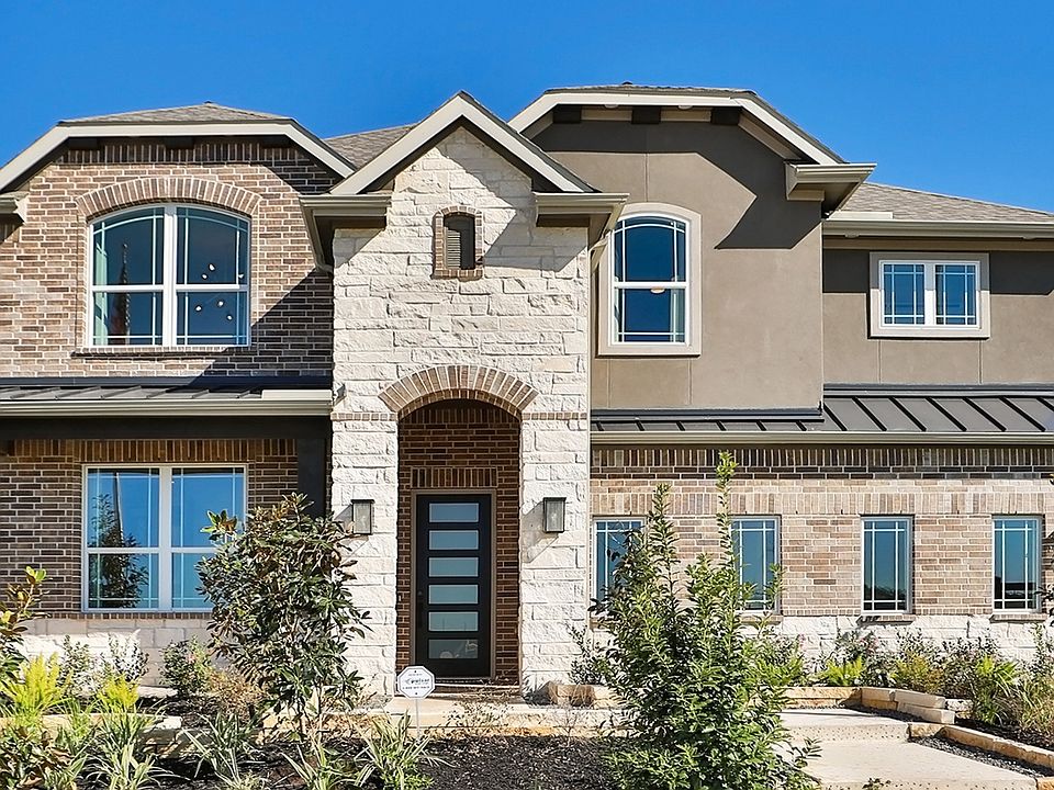 Exquisite brickwork and arched windows define this modern Brookewater residence.