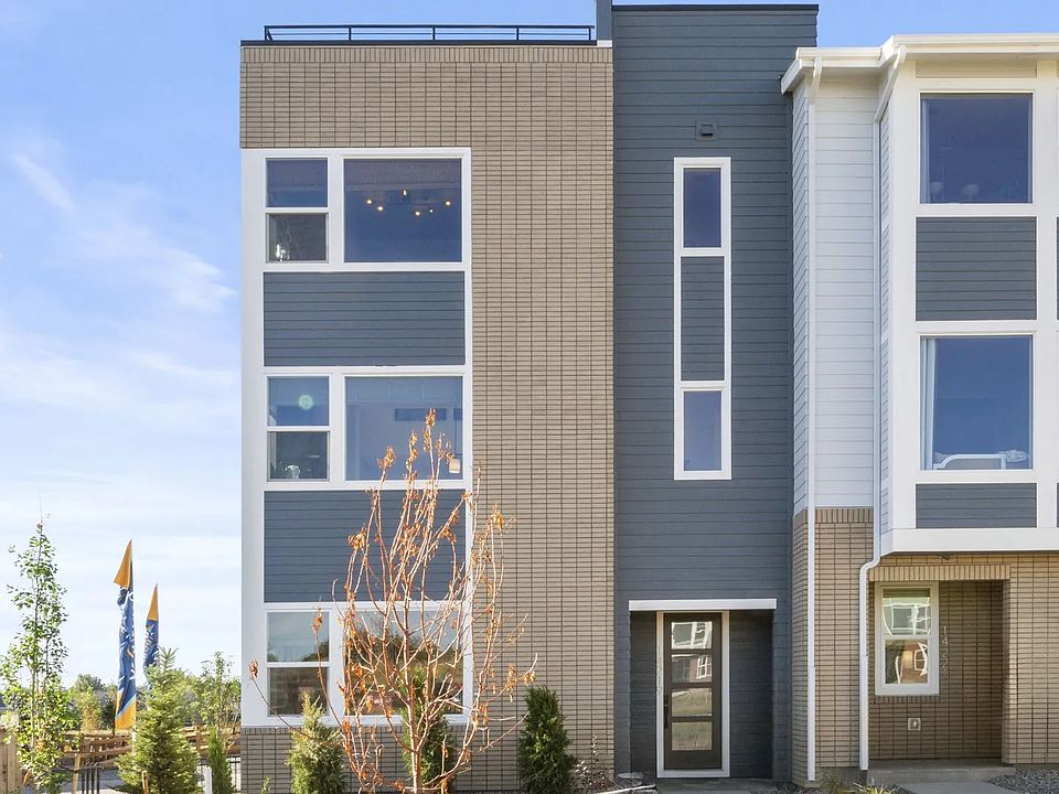 Elegant brick facade and expansive windows define this Dillon Pointe townhouse s modern luxury.