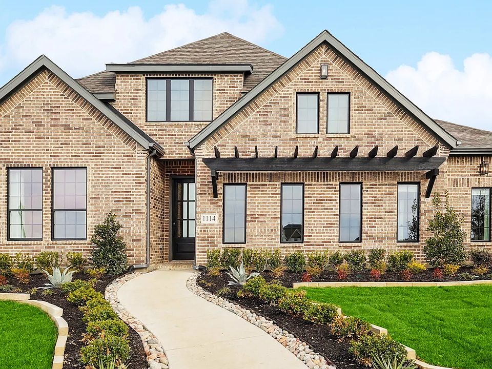 Experience refined elegance with brick exterior, expansive windows, in Westside Preserve.
