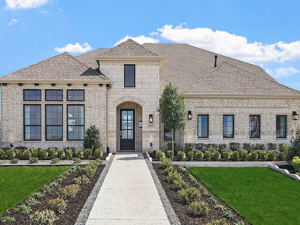 Distinctive brick facade and expansive windows define this exquisite Kelly Ranch residence.