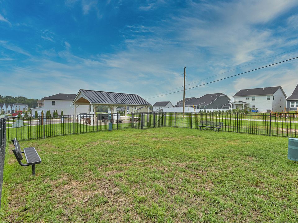 Helmsley Place 55 Townhomes offers community amenities including a covered pavilion and dog park.