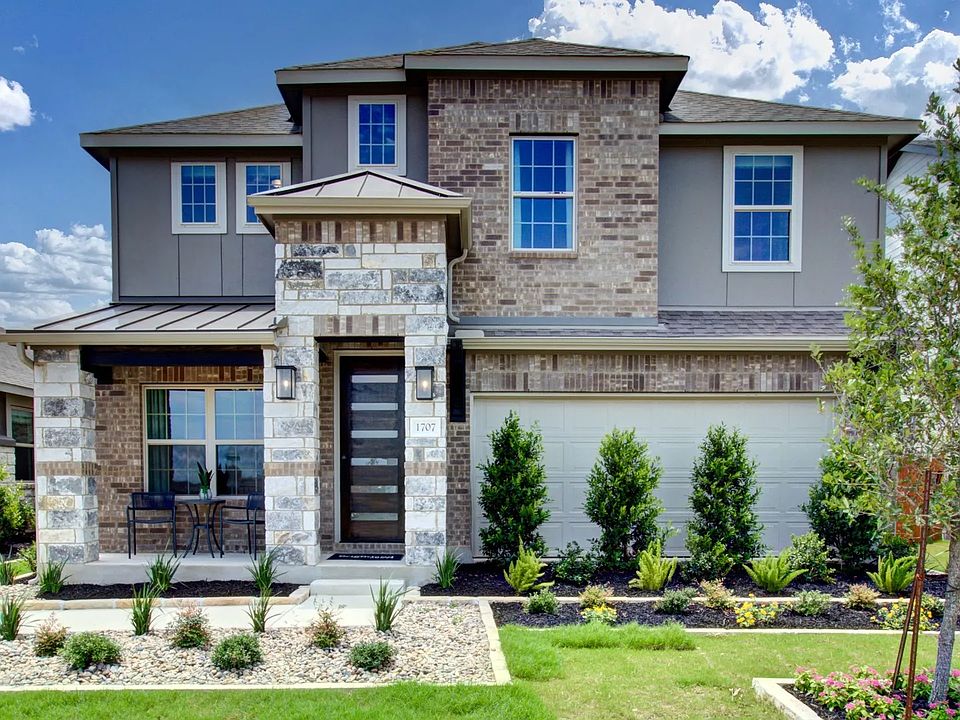 Elegant Meyer Ranch home features a stately brick facade, stone accents, and pristine landscaping fo