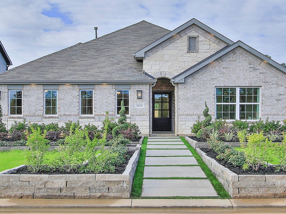 Luxurious stone facade with pristine landscaping in Colony at Pinehurst, Texas.