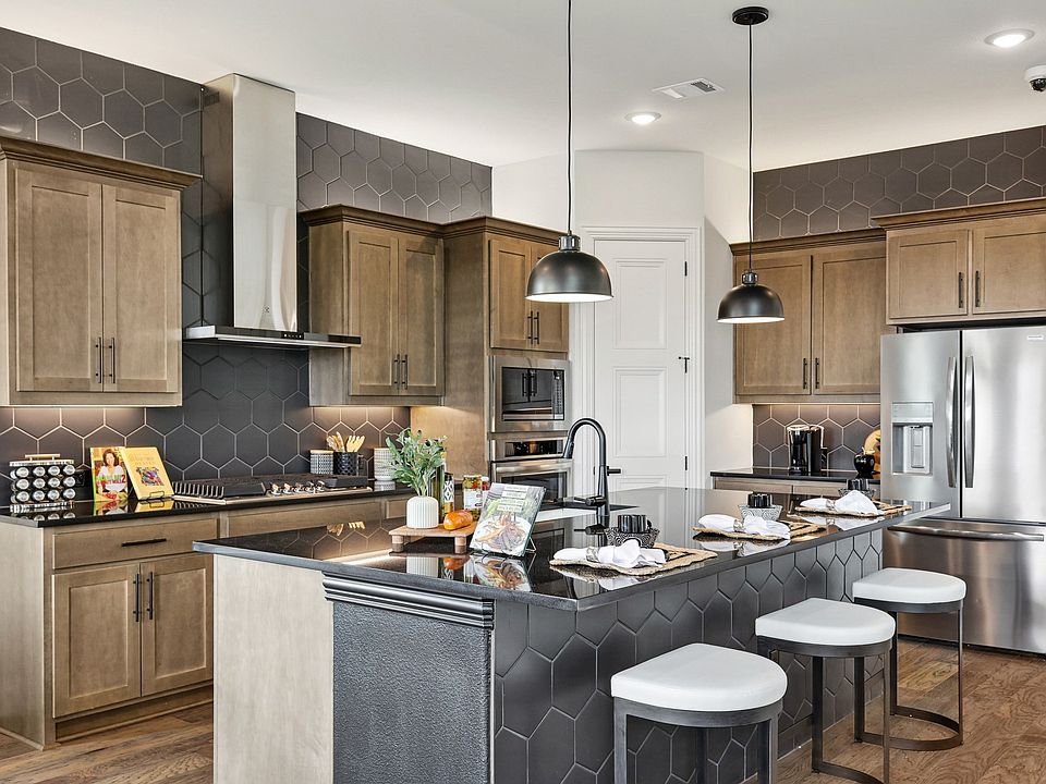 Elegant Morningside kitchen showcases chic hexagonal backsplash and refined wood cabinetry, creating